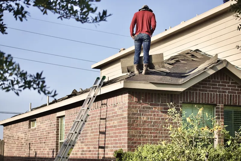 Professional roofer working on a residential roof in Maiden Creek Estates